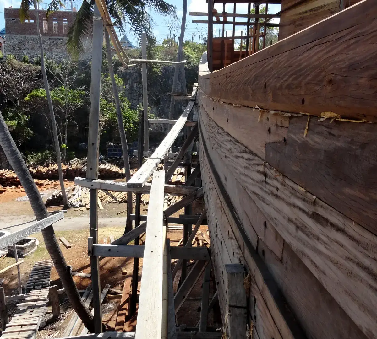 The planked side of a wooden phinisi hull under construction at Bira Beach
